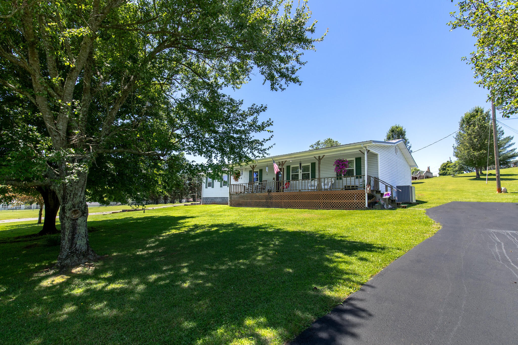 219 Corbin Lake Road Rutledge, TN 37861 - Photo 1 of 41 a front view of a house with garden and porch