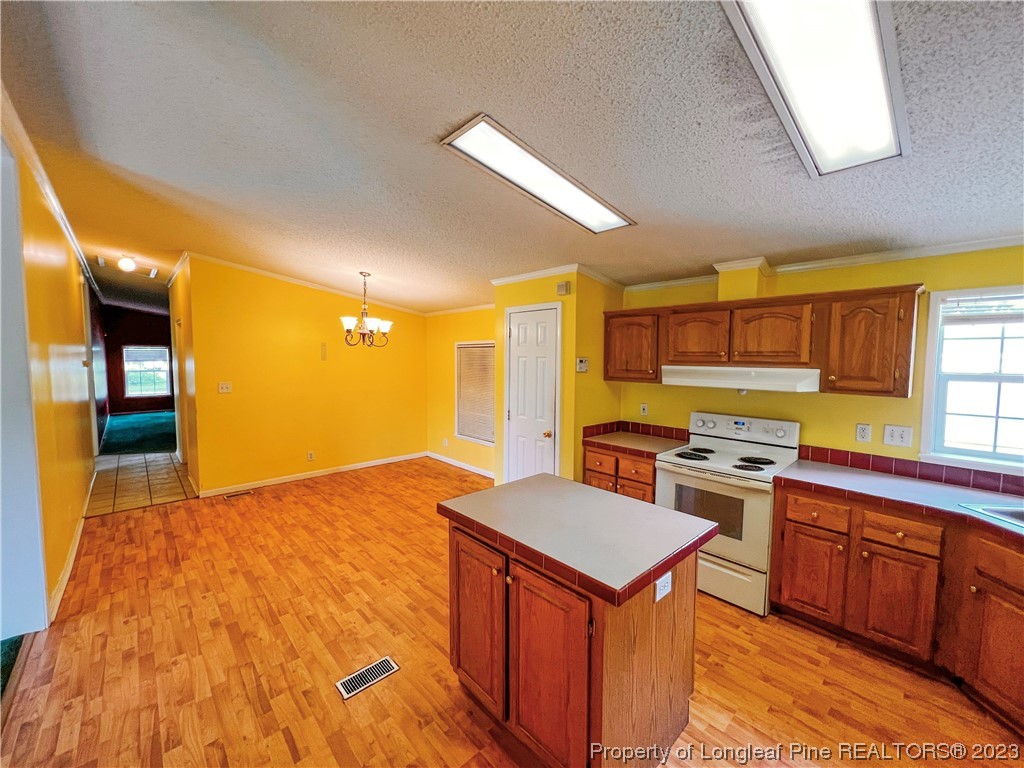 74 Decker Road St. Pauls, NC 28384 - Photo 29 of 46 a kitchen with a stove a sink and a refrigerator