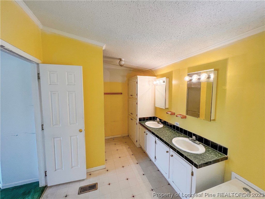 74 Decker Road St. Pauls, NC 28384 - Photo 39 of 46 a kitchen with granite countertop a sink and a stove top oven