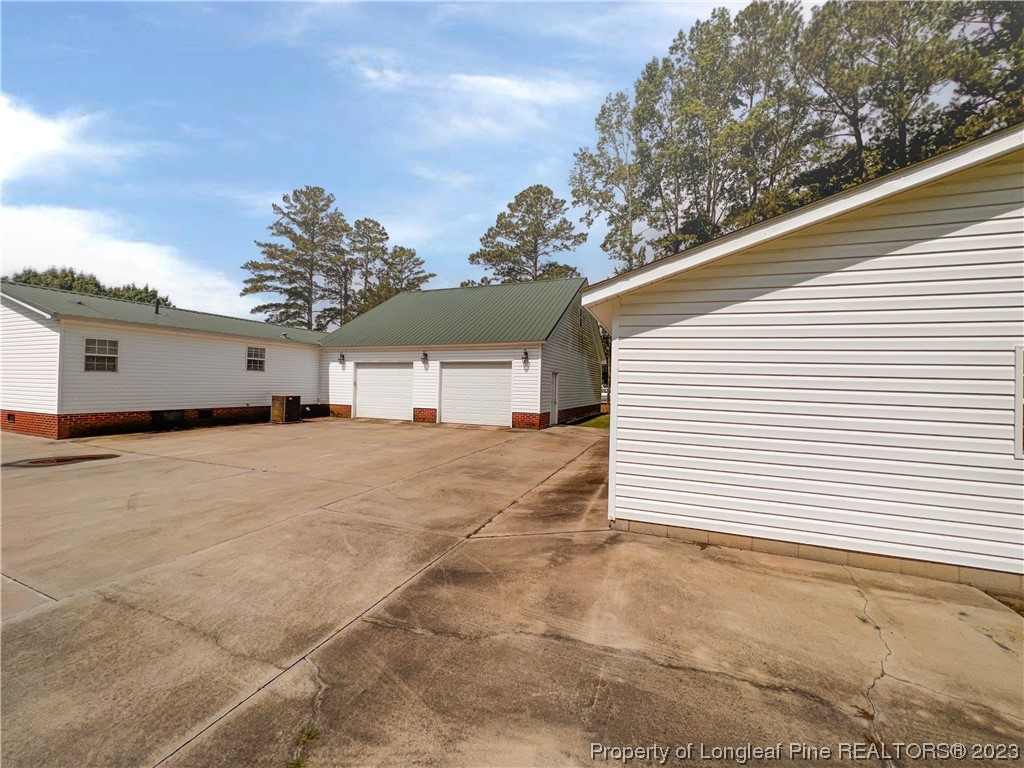 74 Decker Road St. Pauls, NC 28384 - Photo 6 of 46 a view of a white house with a yard and garage