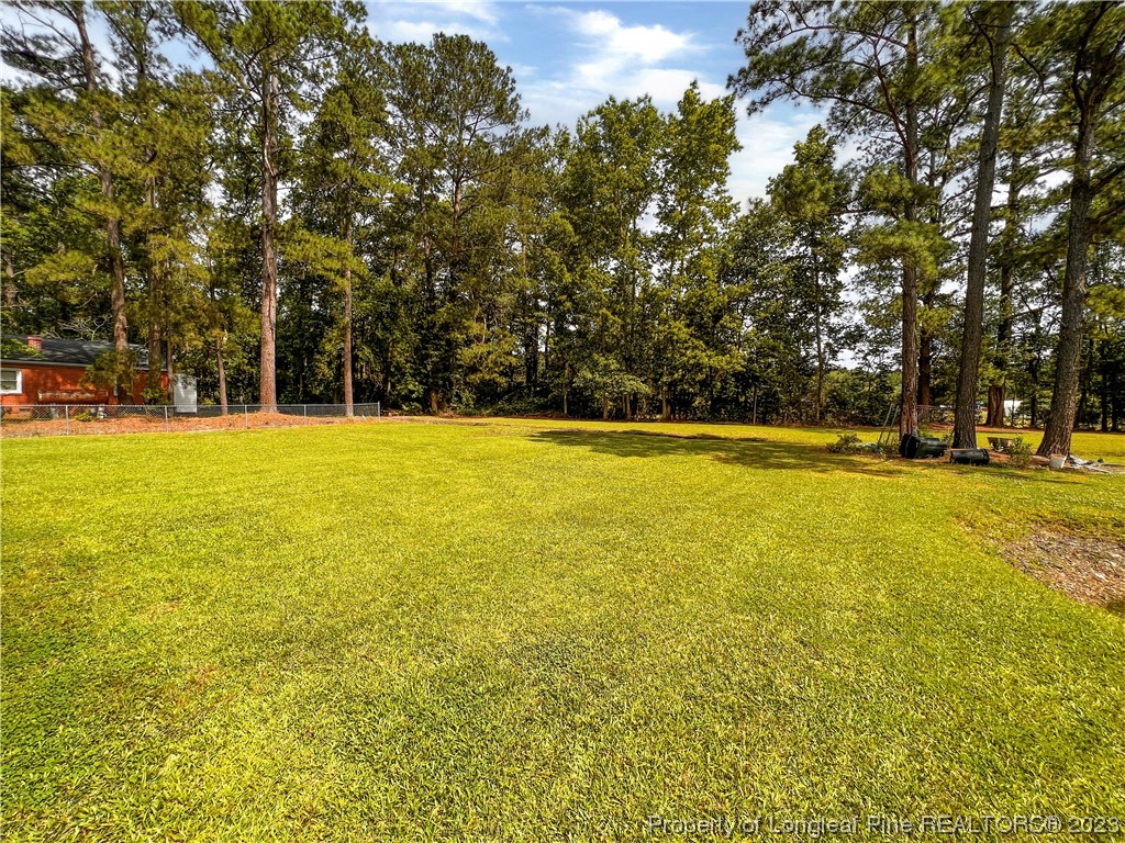 74 Decker Road St. Pauls, NC 28384 - Photo 7 of 46 a view of swimming pool with an outdoor space and seating area
