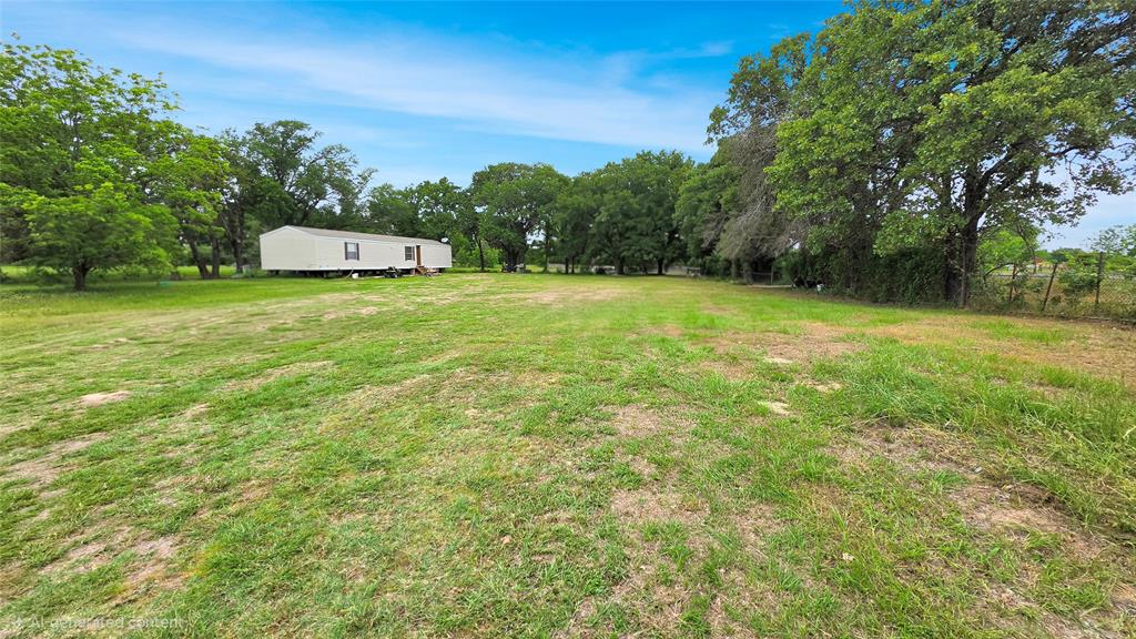 14628 Fm Road Scurry, TX 75158 - Photo 1 of 14 a picture of a big yard with large trees
