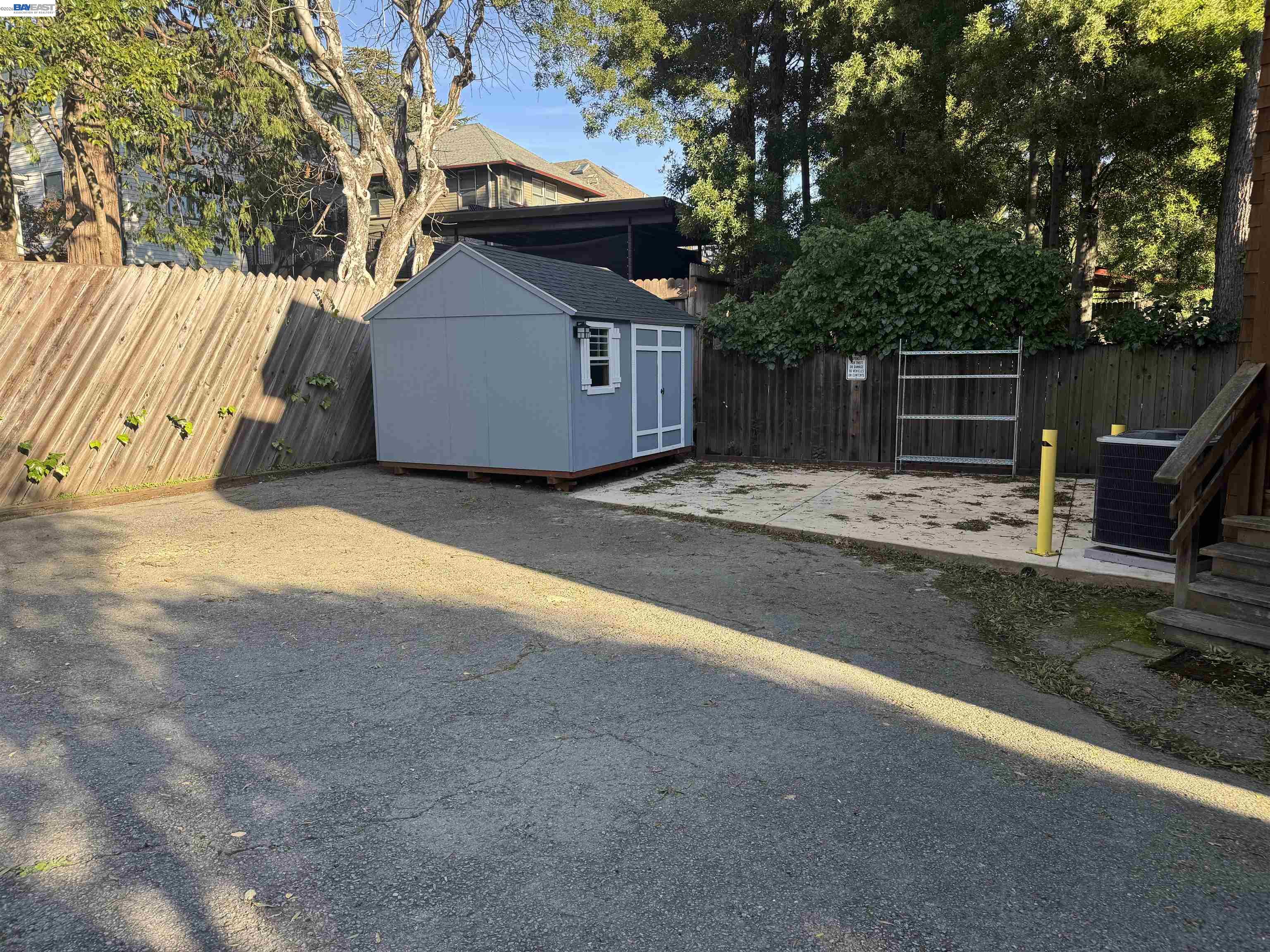 1836 Fifth Avenue San Rafael, CA 94901 - Photo 15 of 15 a backyard of a house with wooden fence and large trees