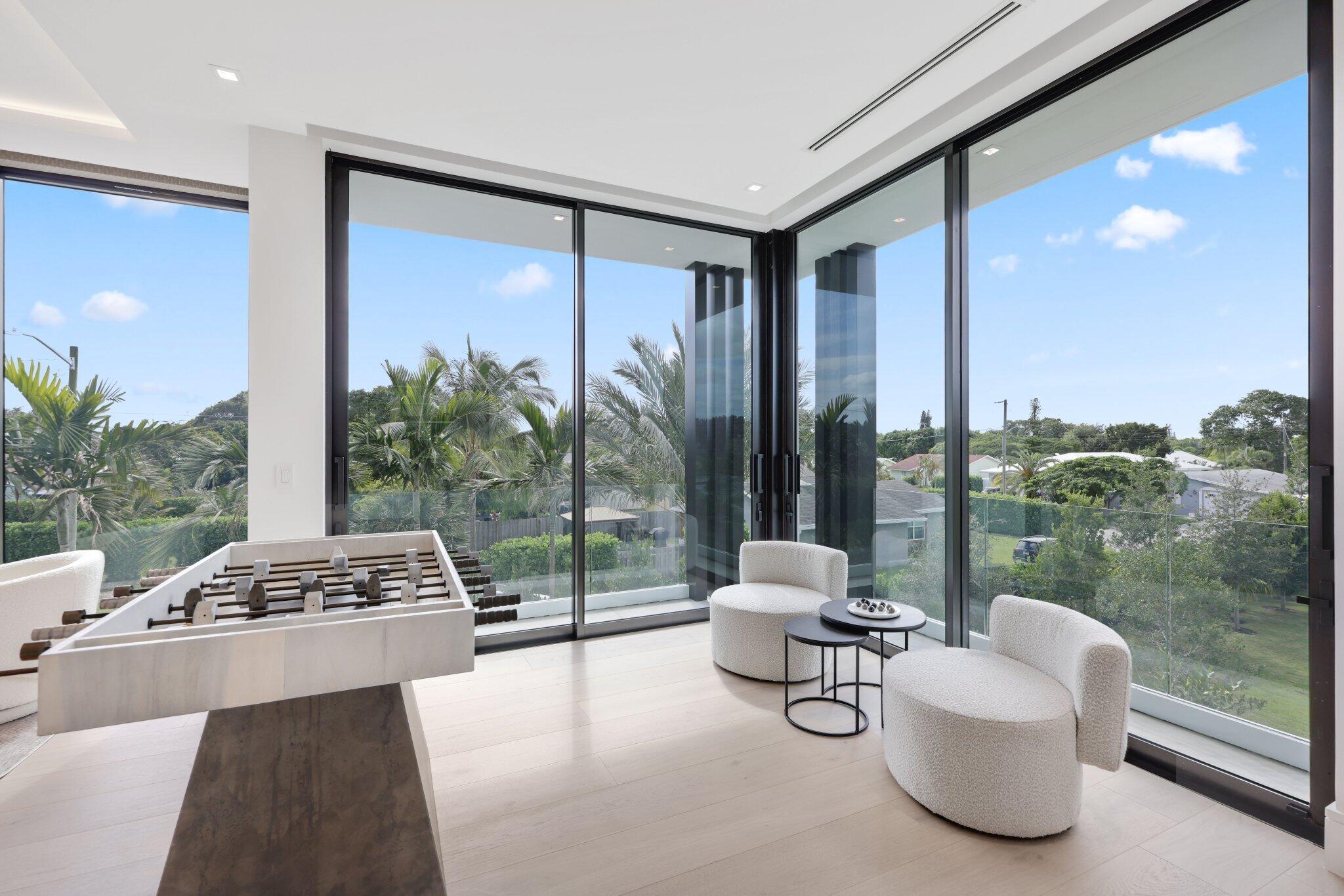 310 Grove Place Delray Beach, FL 33444 - Photo 39 of 92 a living room with patio furniture and a floor to ceiling window