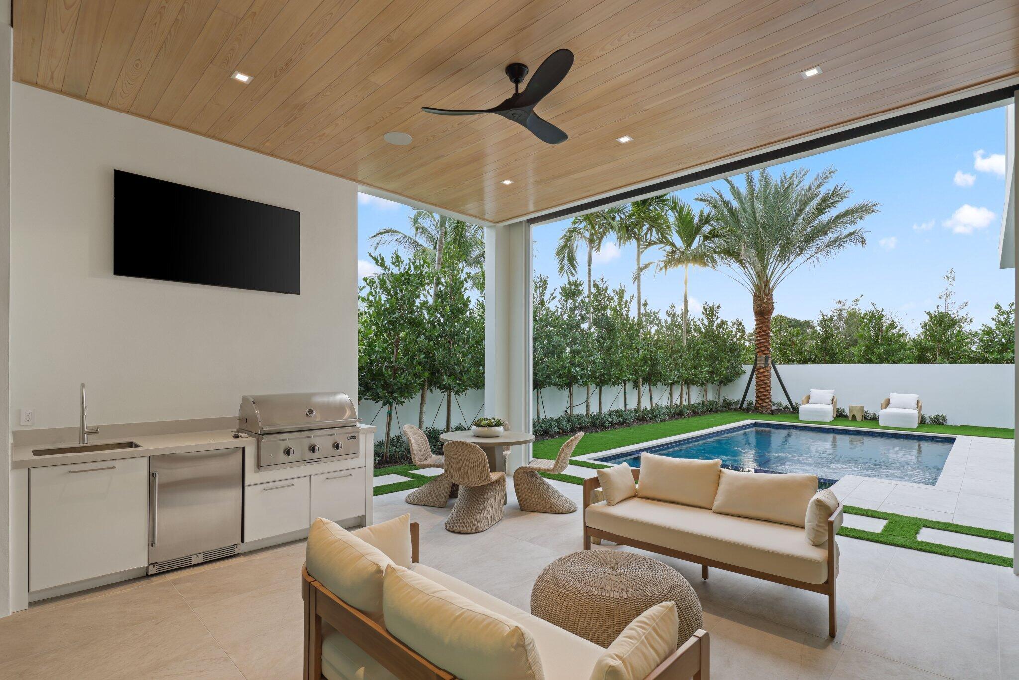310 Grove Place Delray Beach, FL 33444 - Photo 4 of 92 a living room with furniture a flat screen tv and a large window