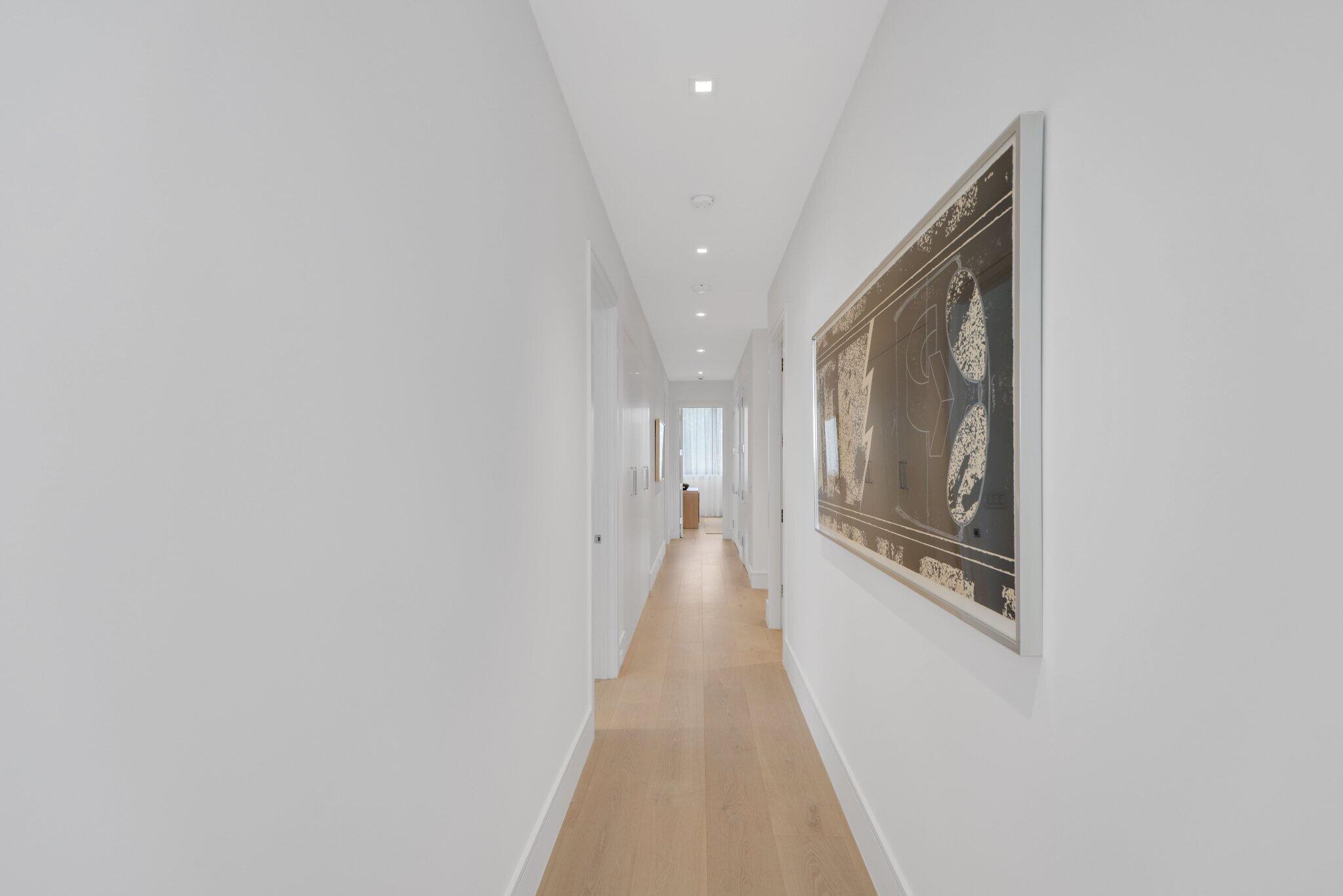 310 Grove Place Delray Beach, FL 33444 - Photo 45 of 92 a hallway with wooden floor and staircase