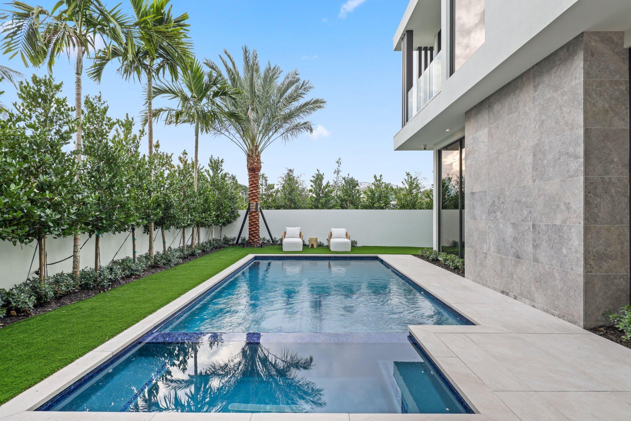 310 Grove Place Delray Beach, FL 33444 - Photo 64 of 92 a view of a backyard with a swimming pool