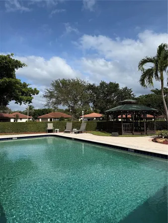 a view of a swimming pool with a yard
