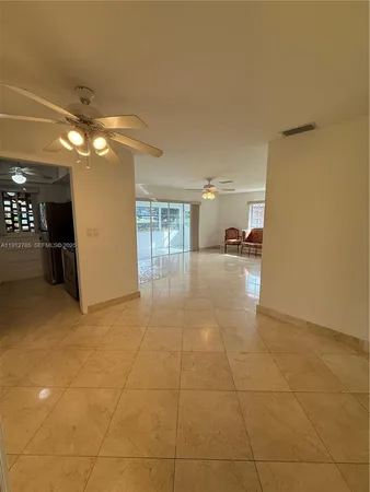 a view of a livingroom with furniture and a ceiling fan