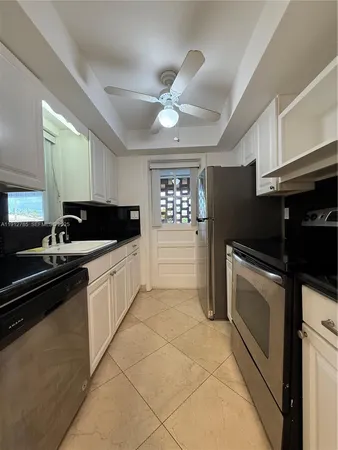 a kitchen with a sink cabinets and stainless steel appliances