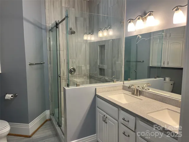 a bathroom with a tub sink and mirror