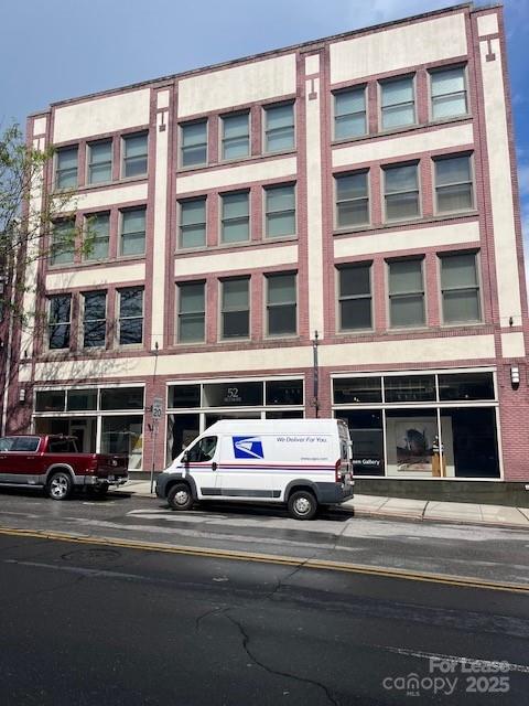 52 Biltmore Avenue, Unit 203 Asheville, NC 28801 - Photo 2 of 17 a cars parked in front of a building