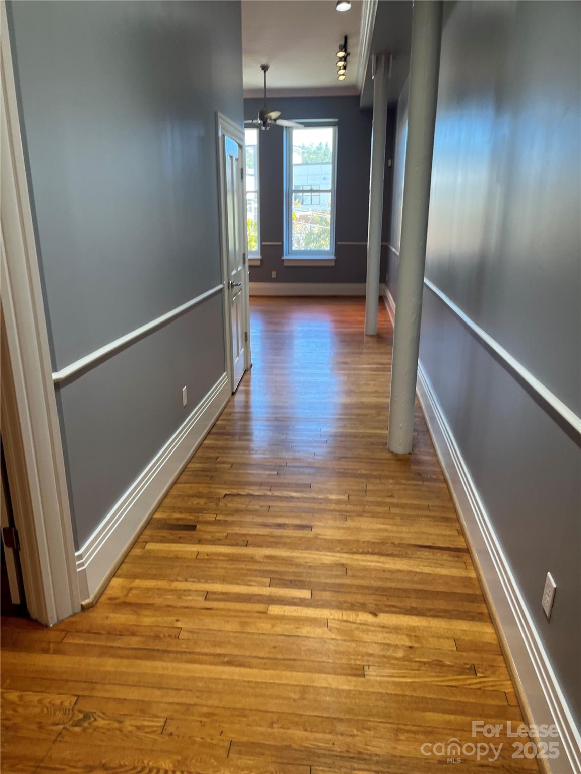 52 Biltmore Avenue, Unit 203 Asheville, NC 28801 - Photo 3 of 17 a view of an empty room with wooden floor and a window