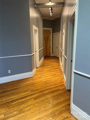 a view of a room with wooden floor