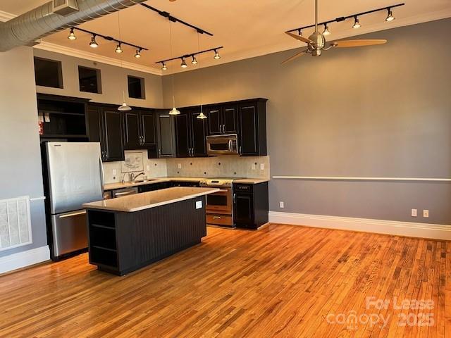 52 Biltmore Avenue, Unit 203 Asheville, NC 28801 - Photo 6 of 17 a large kitchen with stainless steel appliances granite countertop a stove and a refrigerator