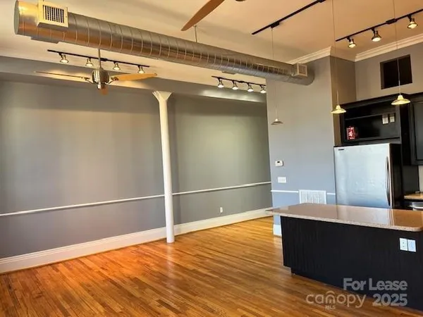 a view of a living room with wooden floor