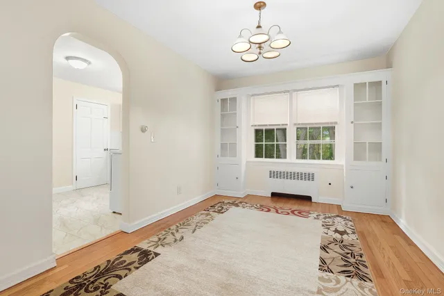 a view of a bedroom with wooden floor and a window