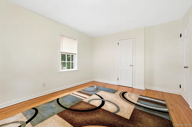 a view of a room with furniture and wooden floor