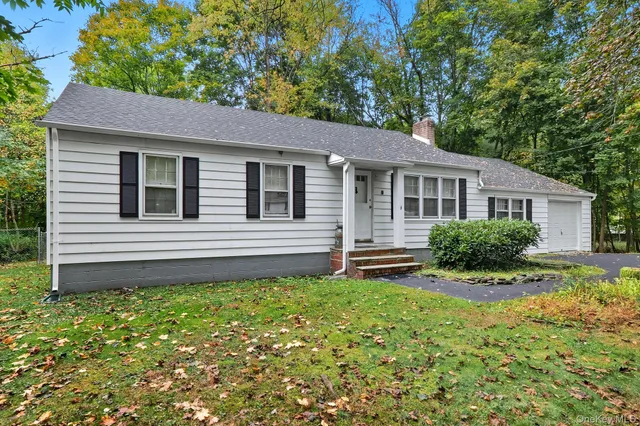 a house that has a tree in front of the house