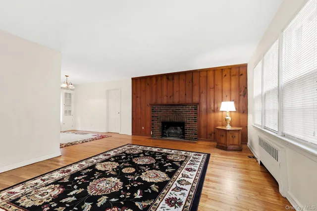 a living room with a rug and a fireplace