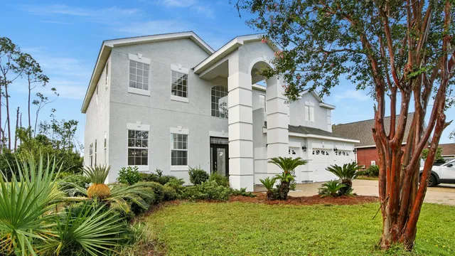 a front view of a house with a garden