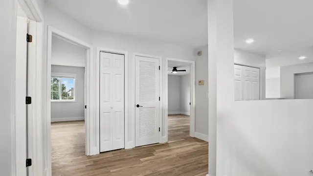 a view of a hallway with wooden floor