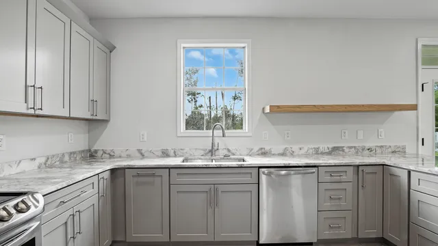 a kitchen with granite countertop white cabinets and white appliances