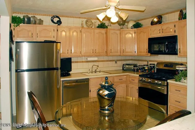 a kitchen with a refrigerator a stove and a microwave