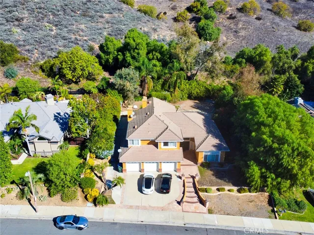an aerial view of a house with a yard