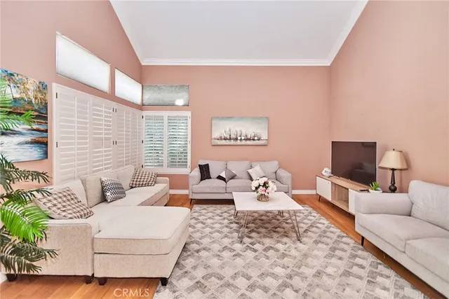 a living room with furniture wooden floor and a flat screen tv