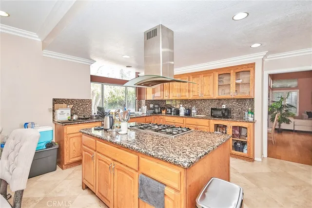 a kitchen with stainless steel appliances granite countertop wooden cabinets and a granite counter tops