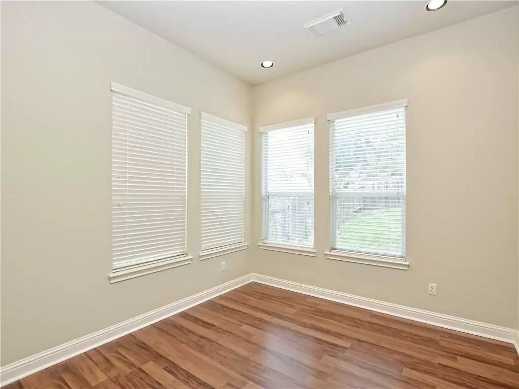7005 Via Correto Drive Austin, TX 78749 - Photo 16 of 27 an empty room with wooden floor and windows