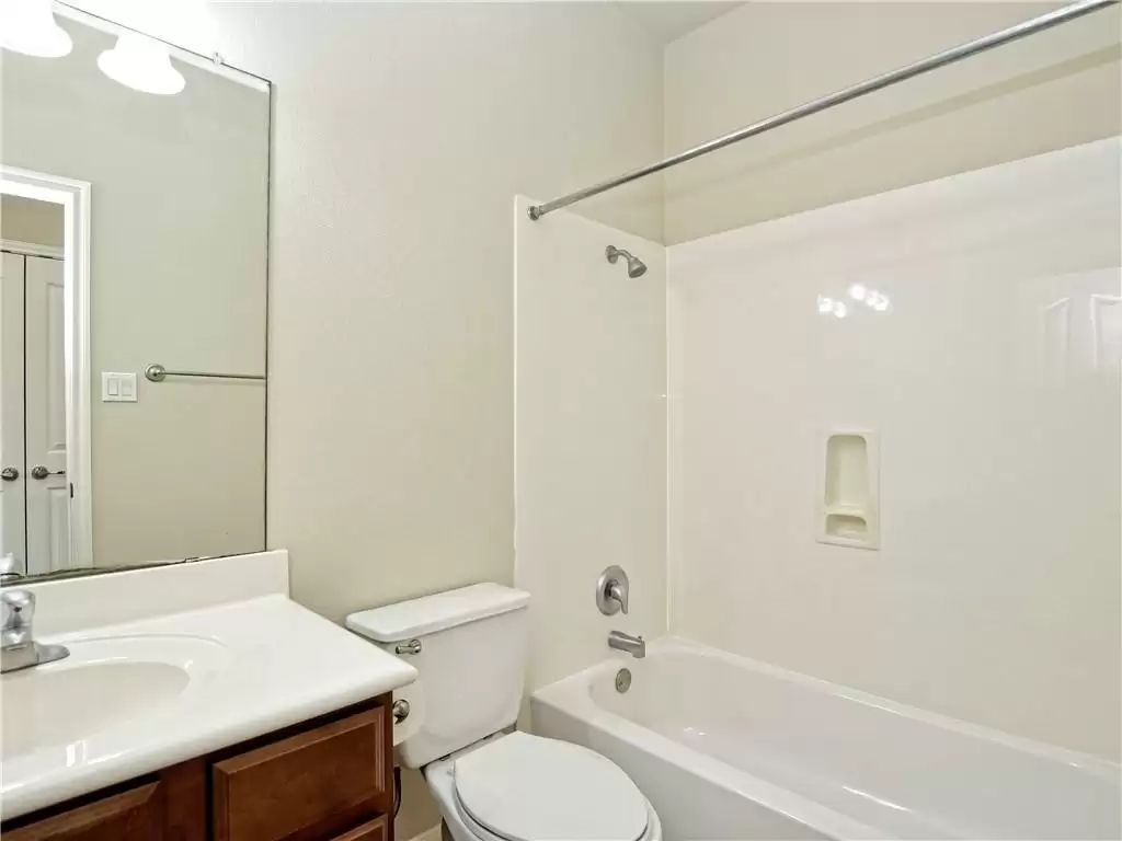 7005 Via Correto Drive Austin, TX 78749 - Photo 18 of 27 a bathroom with a sink toilet vanity and shower
