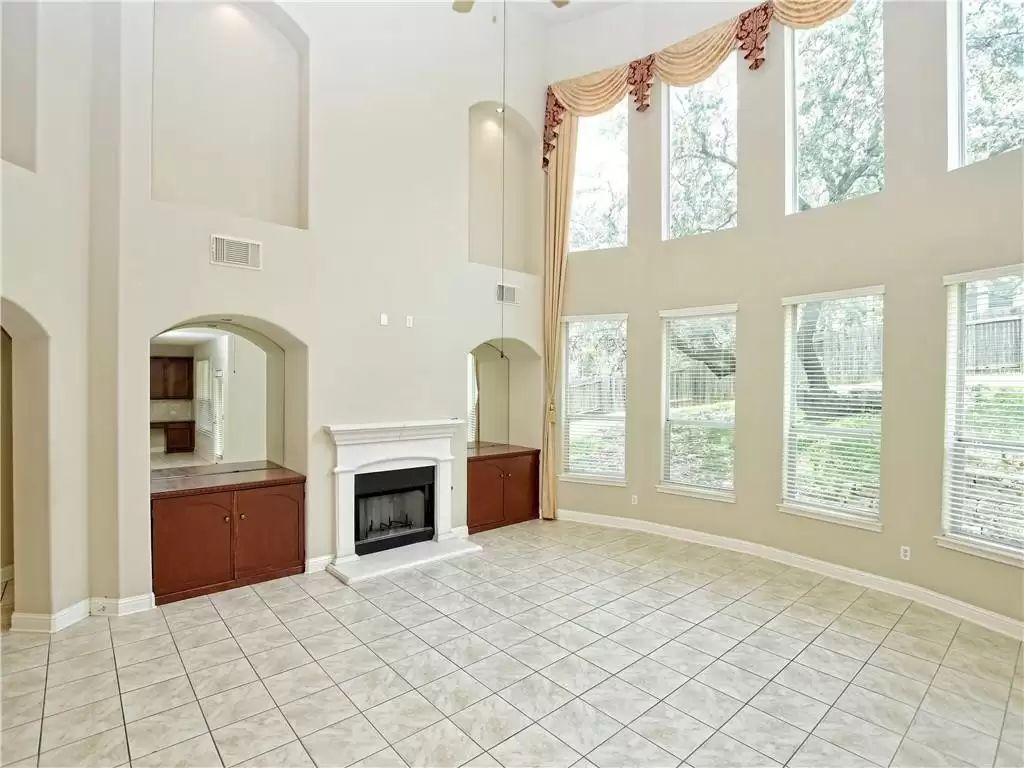 7005 Via Correto Drive Austin, TX 78749 - Photo 2 of 27 a view of an empty room with a fireplace and a window