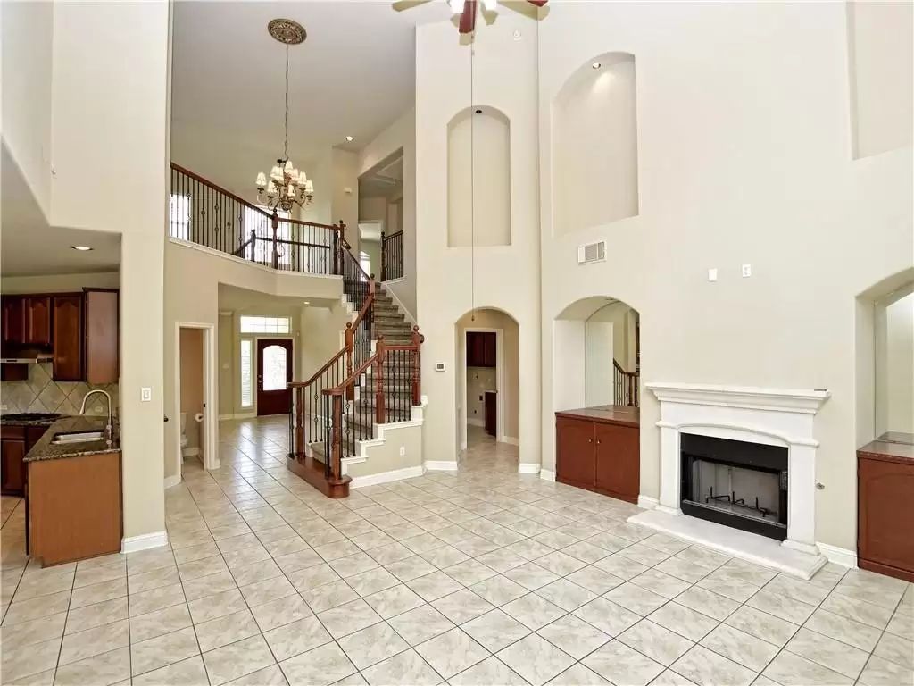 7005 Via Correto Drive Austin, TX 78749 - Photo 4 of 27 a living room with fireplace furniture and a chandelier