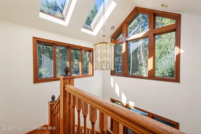 a kitchen with granite countertop a sink and dishwasher a oven with white cabinets