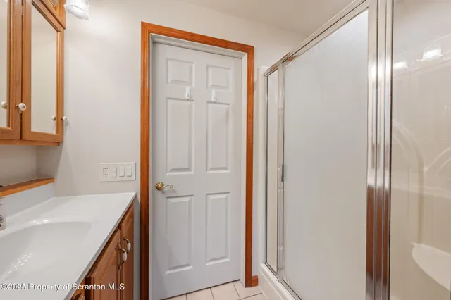 a bathroom with a granite countertop toilet a sink and a mirror