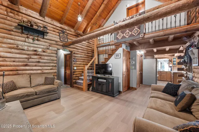 a view of a balcony with wooden floor and fence