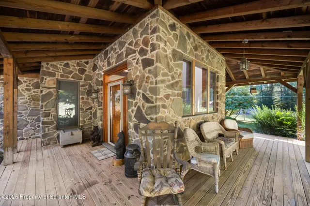 a view of a roof deck with chair and wooden floor