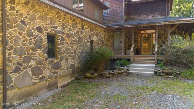a view of a swimming pool with a bench and trees in the background