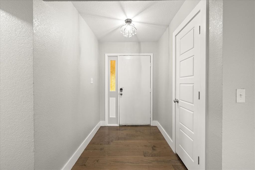 1405 Timberline Drive Benbrook, TX 76126 - Photo 13 of 26 a view of a hallway with a chandelier fan