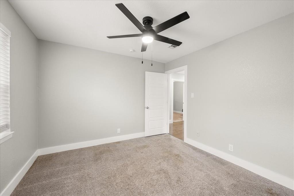 1405 Timberline Drive Benbrook, TX 76126 - Photo 14 of 26 an empty room with ceiling fan and window