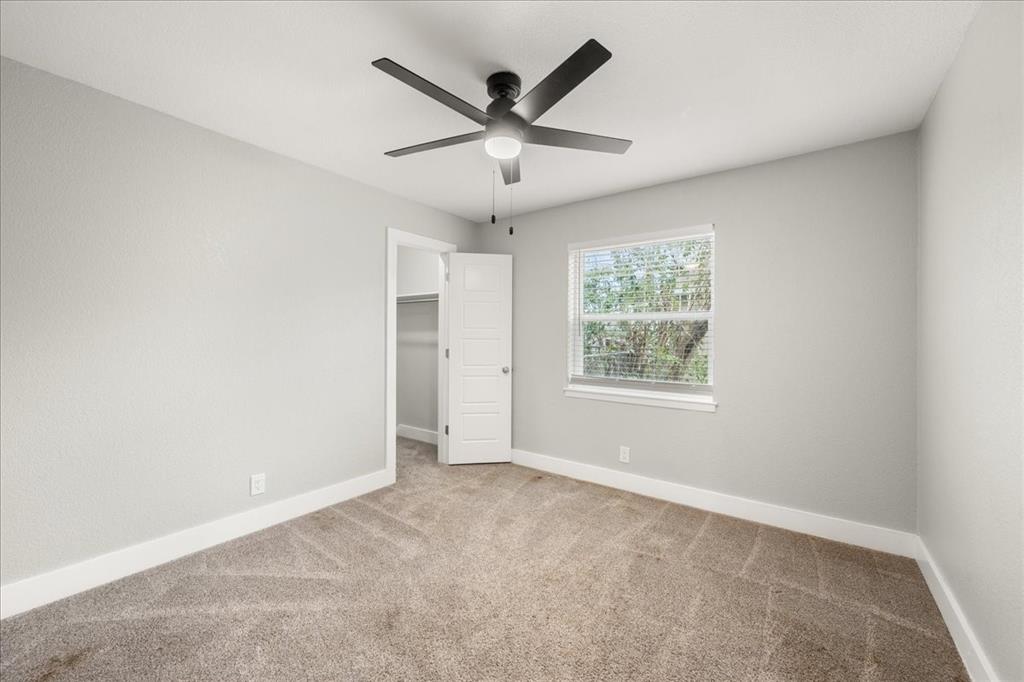 1405 Timberline Drive Benbrook, TX 76126 - Photo 15 of 26 an empty room with ceiling fan and windows