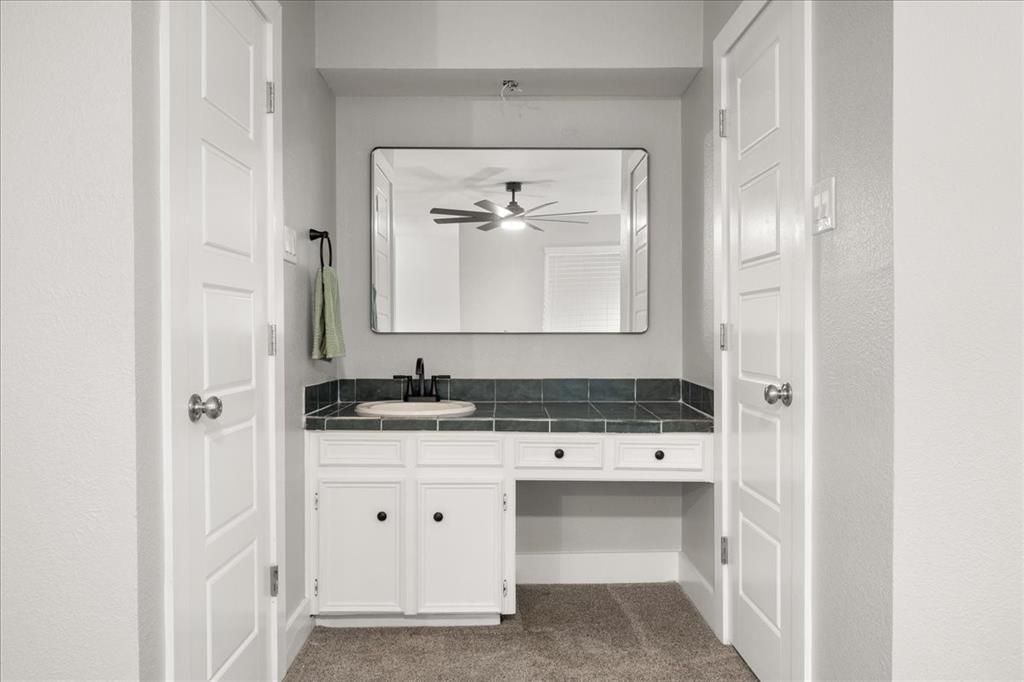 1405 Timberline Drive Benbrook, TX 76126 - Photo 17 of 26 a bathroom with a sink and a mirror