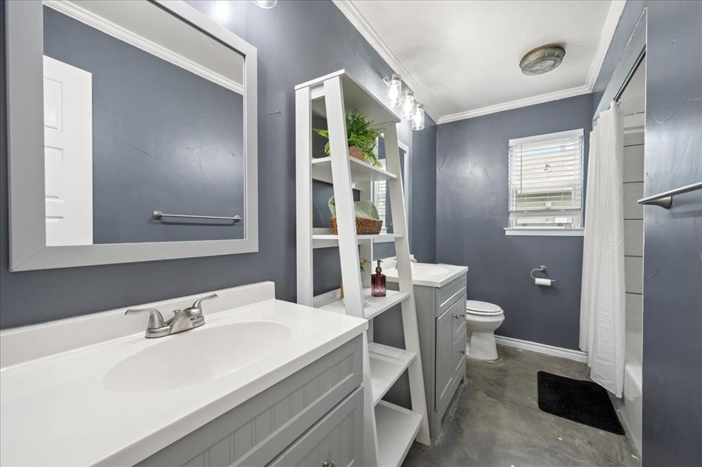 1405 Timberline Drive Benbrook, TX 76126 - Photo 21 of 26 a bathroom with a sink and a toilet