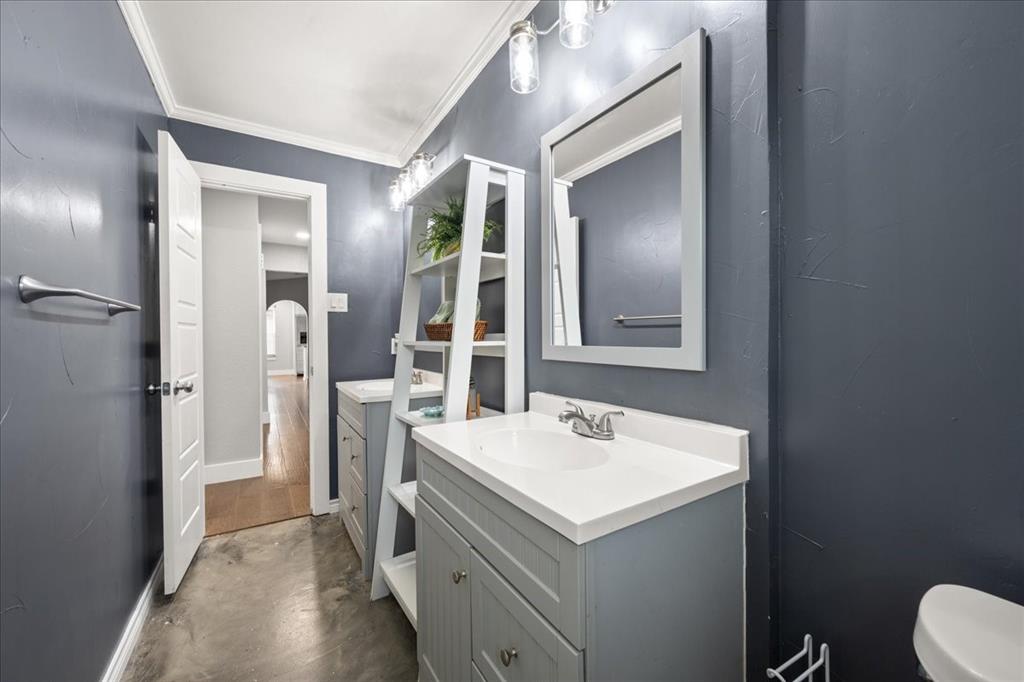 1405 Timberline Drive Benbrook, TX 76126 - Photo 23 of 26 a bathroom with a sink mirror and toilet