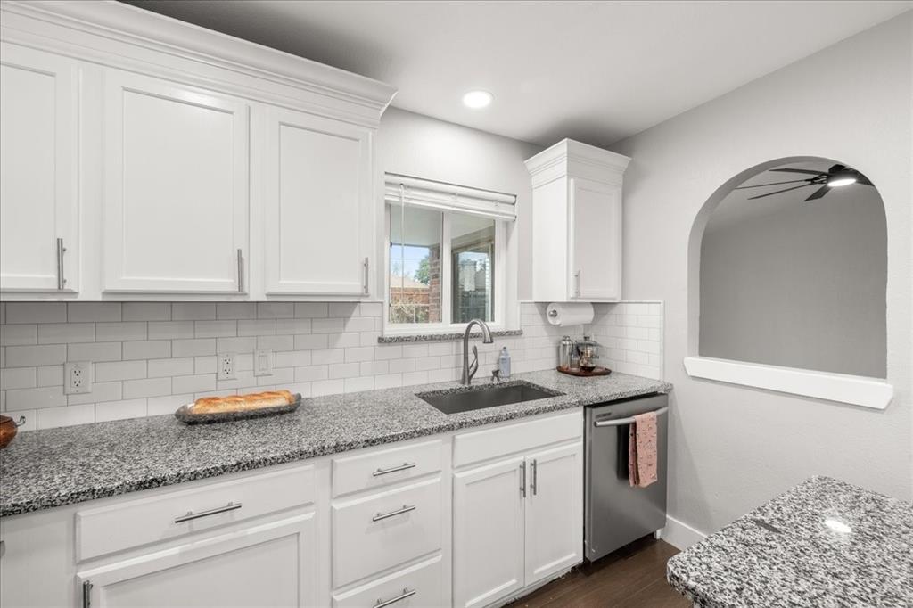 1405 Timberline Drive Benbrook, TX 76126 - Photo 8 of 26 a kitchen with granite countertop white cabinets and sink
