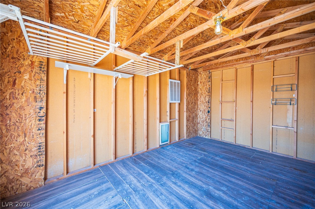 3200 Maple Road Pahrump, NV 89048 - Photo 46 of 53 Functional garage with overhead shelving and durable flooring provides ample storage solutions.