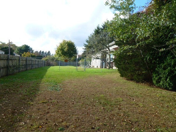 310 Bakerville Road Dartmouth, MA 02748 - Photo 5 of 19 a view of a field with trees in background