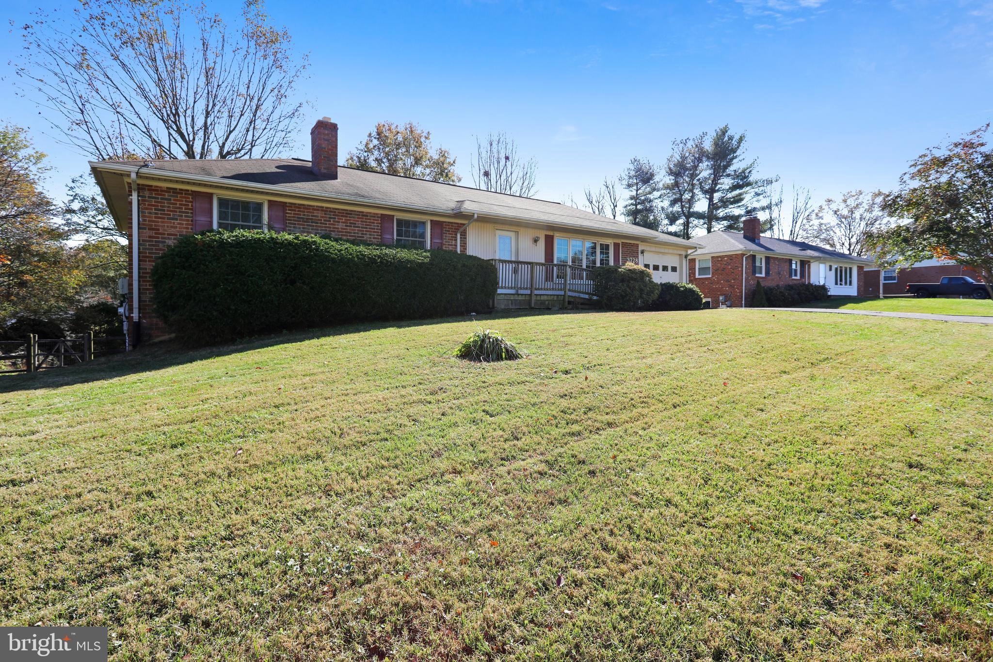 3728 Briars Road Olney, MD 20832 - Photo 4 of 54 a front view of house with yard and trees in the background